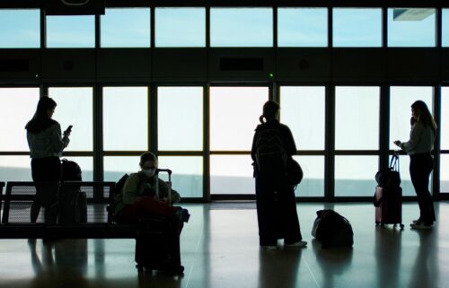 People wait for the air train to connect with their flights at Newark Liberty International Airport on May 12.