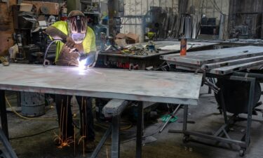 A worker arc welds a metal door during production at the Metal Manufacturing Co. facility in Sacramento