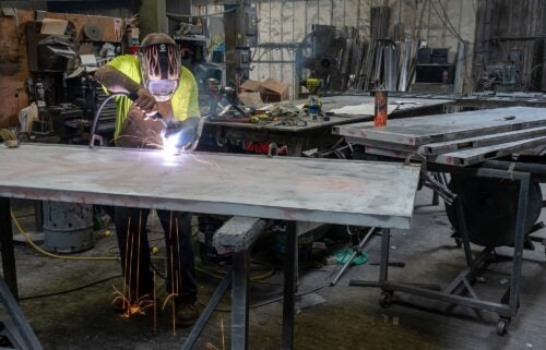 A worker arc welds a metal door during production at the Metal Manufacturing Co. facility in Sacramento