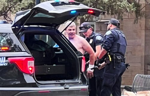 Law enforcement officers detain a suspect after an attack that injured multiple people in Boulder