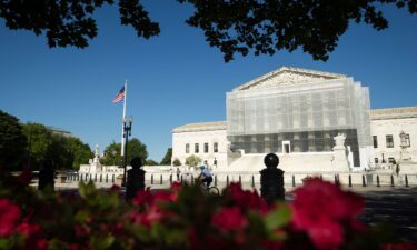 Construction scaffolding covers the facade of the Supreme Court in Washington
