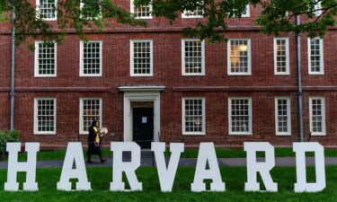 A students walks past a display on the Harvard University campus in Cambridge