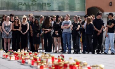 Mourners gather to observe a minute of silence for the victims of the school shooting in Graz