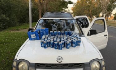 Empty beer cans are arranged on an older model Nissan Xterra following a DUI arrest on June 29.