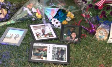 The flowers and balloons are visible at the growing memorial outside MPD District 2. So are the cards and stuffed animals. What cannot be seen are all the prayers that were said there