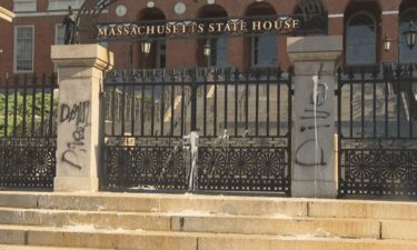 Someone splattered white paint and sprayed black paint onto the front entrance of the Massachusetts State House in Boston on July 23.