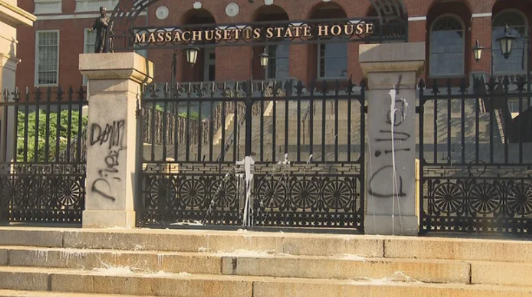 <i>WBZ via CNN Newsource</i><br/>Someone splattered white paint and sprayed black paint onto the front entrance of the Massachusetts State House in Boston on July 23.