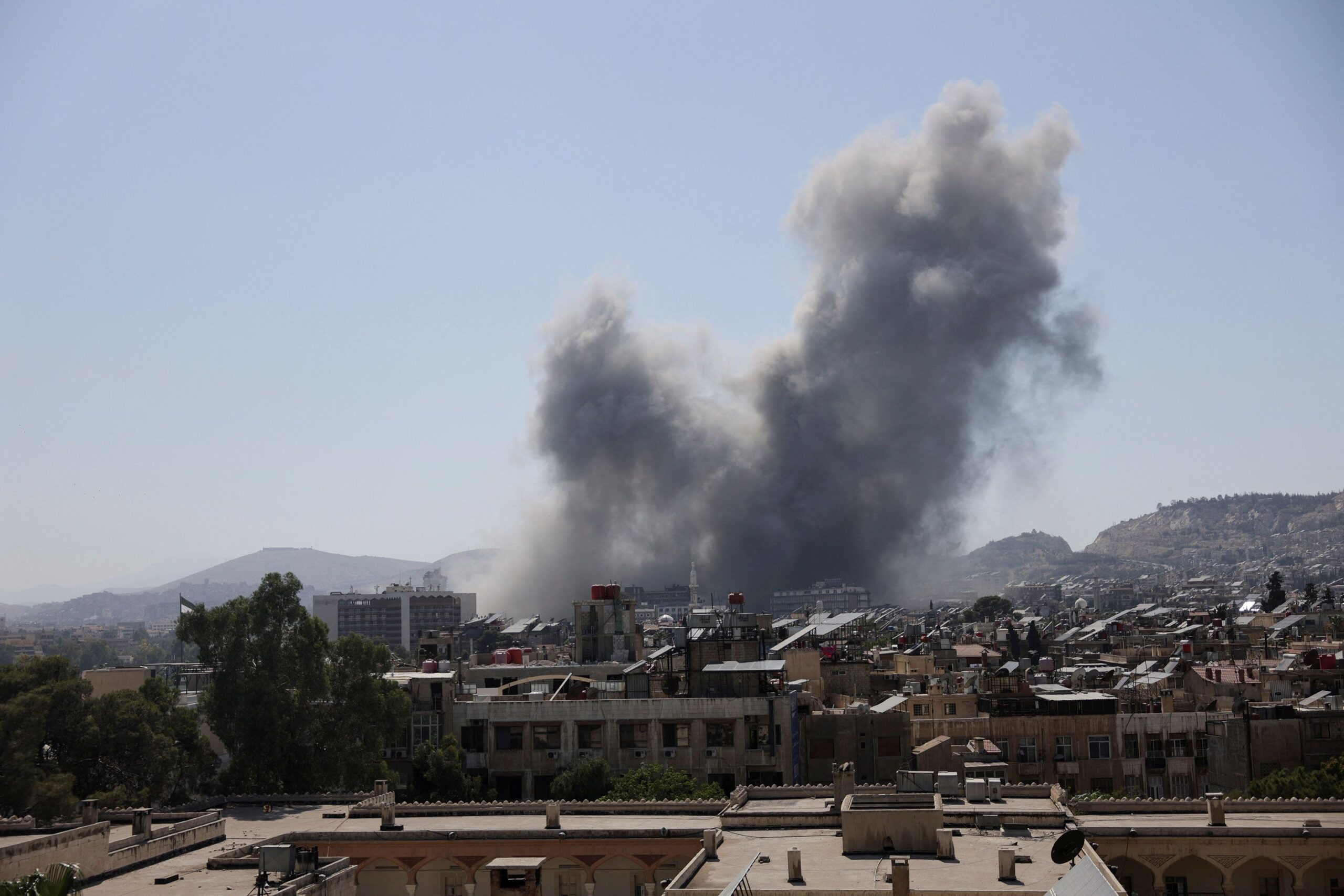 <i>Khalil Ashawi/Reuters via CNN Newsource</i><br/>Smoke rises after strikes on Syria's defense ministry in Damascus on July 16.