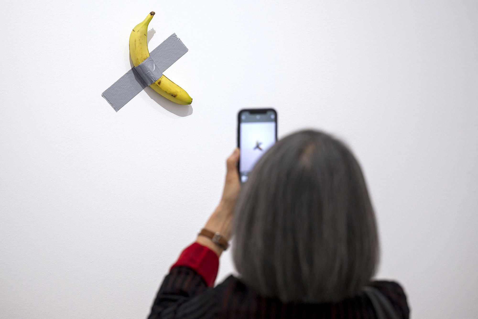 <i>Jean-Christophe Verhaegen/AFP/Getty Images via CNN Newsource</i><br/>"Comedian" by Italian artist Maurizio Cattelan is pictured. Italian artist Maurizio Cattelan’s artwork featuring a fresh banana taped to a wall has been eaten by a visitor to a museum in France.