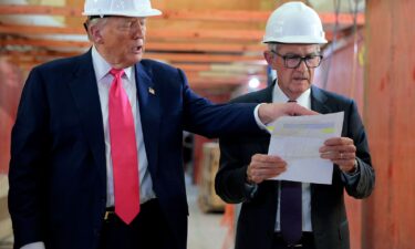 Stuart Levenbach (center) stands with Donald Trump.