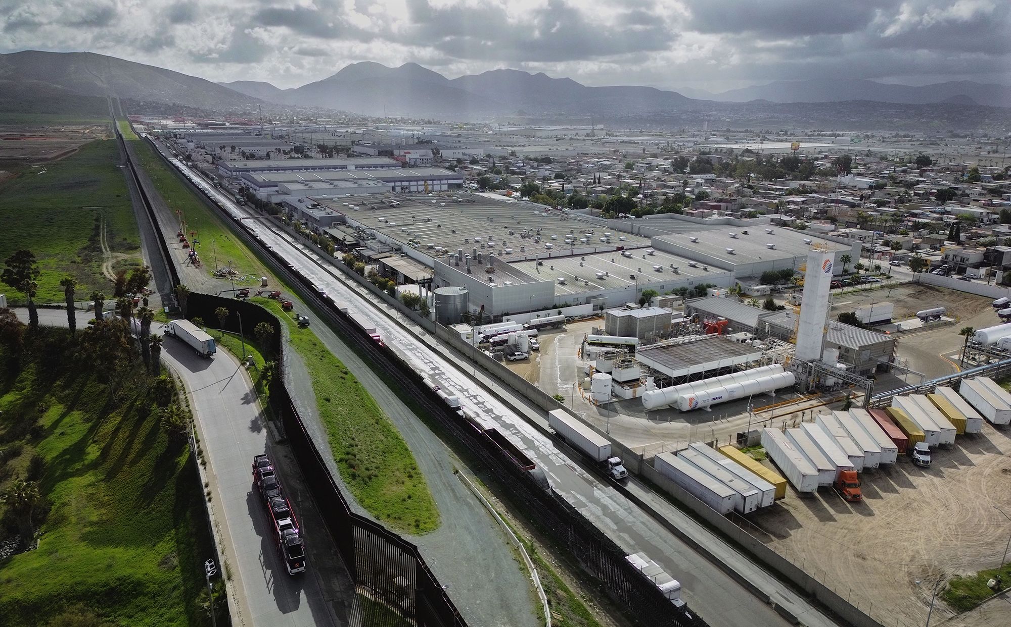 An aerial image shows trucks coming from Mexico enter the US to an inspection station after crossing the border in Otay Mesa, California, on April 2.