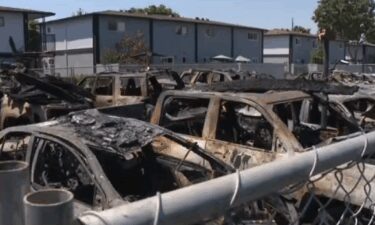 More than two dozen cars were destroyed or damaged in a massive fire at a Santa Ana carport on August 6