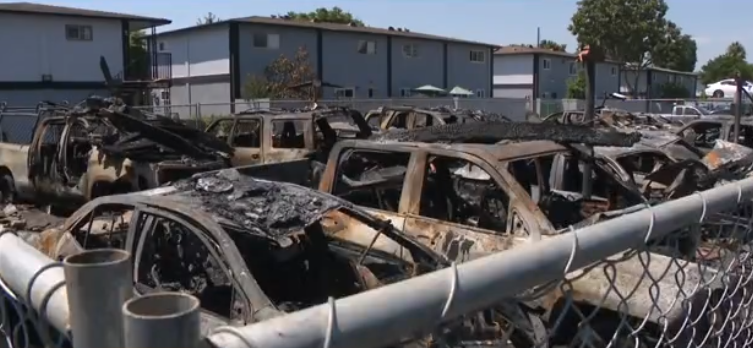 <i>KCAL/KCBS via CNN Newsource</i><br/>More than two dozen cars were destroyed or damaged in a massive fire at a Santa Ana carport on August 6