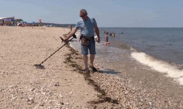 Dave Orlowski uses a metal detector to hunt for history and treasures.