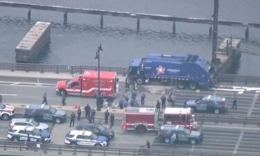 A man remains hospitalized Friday after being shot by police after allegedly stealing a garbage truck and leading police on a chaotic multitown chase that ended in a bridge crash.