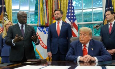 US President Donald Trump listens as Rwanda's foreign minister Olivier Nduhungirehe speaks during an event in the Oval Office at the White House in Washington