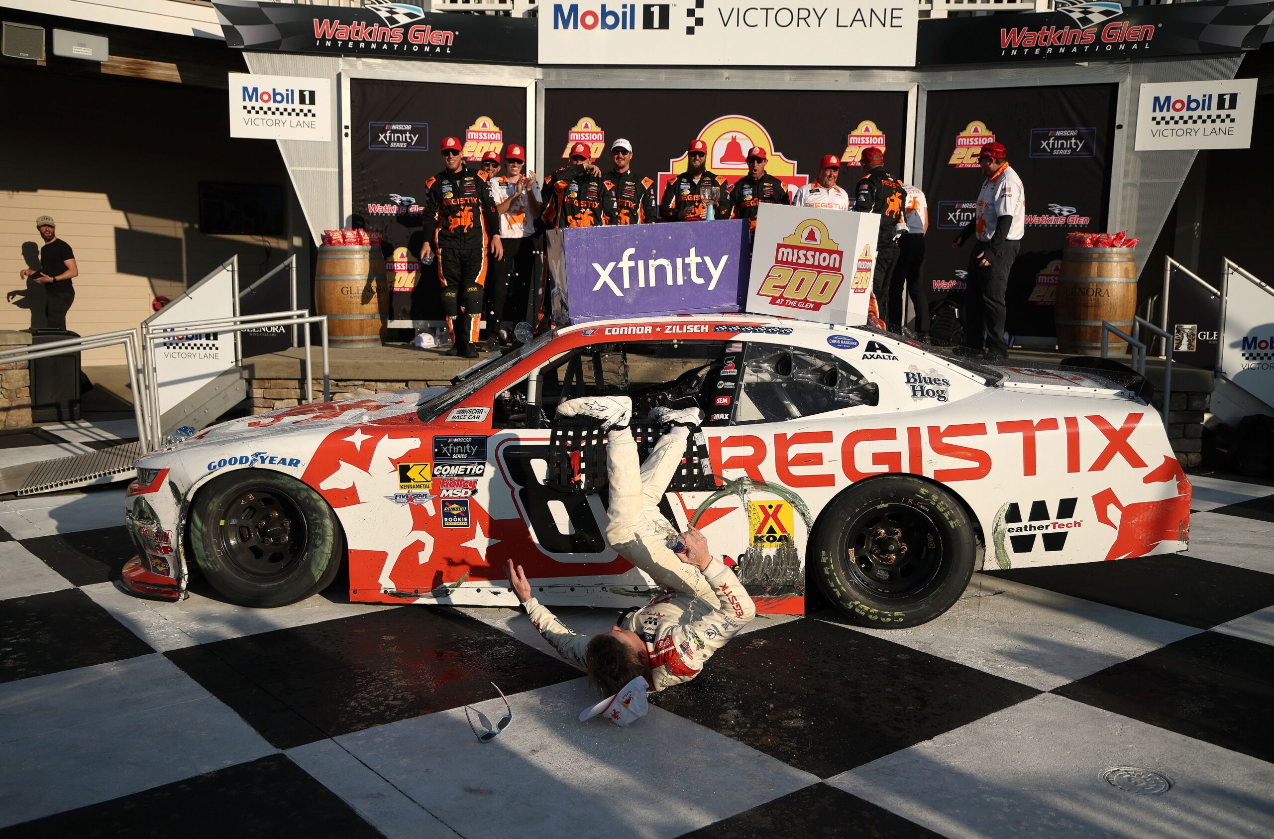 <i>Chris Graythen/Getty Images via CNN Newsource</i><br/>Connor Zilisch slips and falls off his car after winning the NASCAR Xfinity Series' latest race.