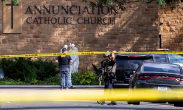 Law enforcement officers set up barriers after a shooting at Annunciation Church in Minneapolis on Wednesday.