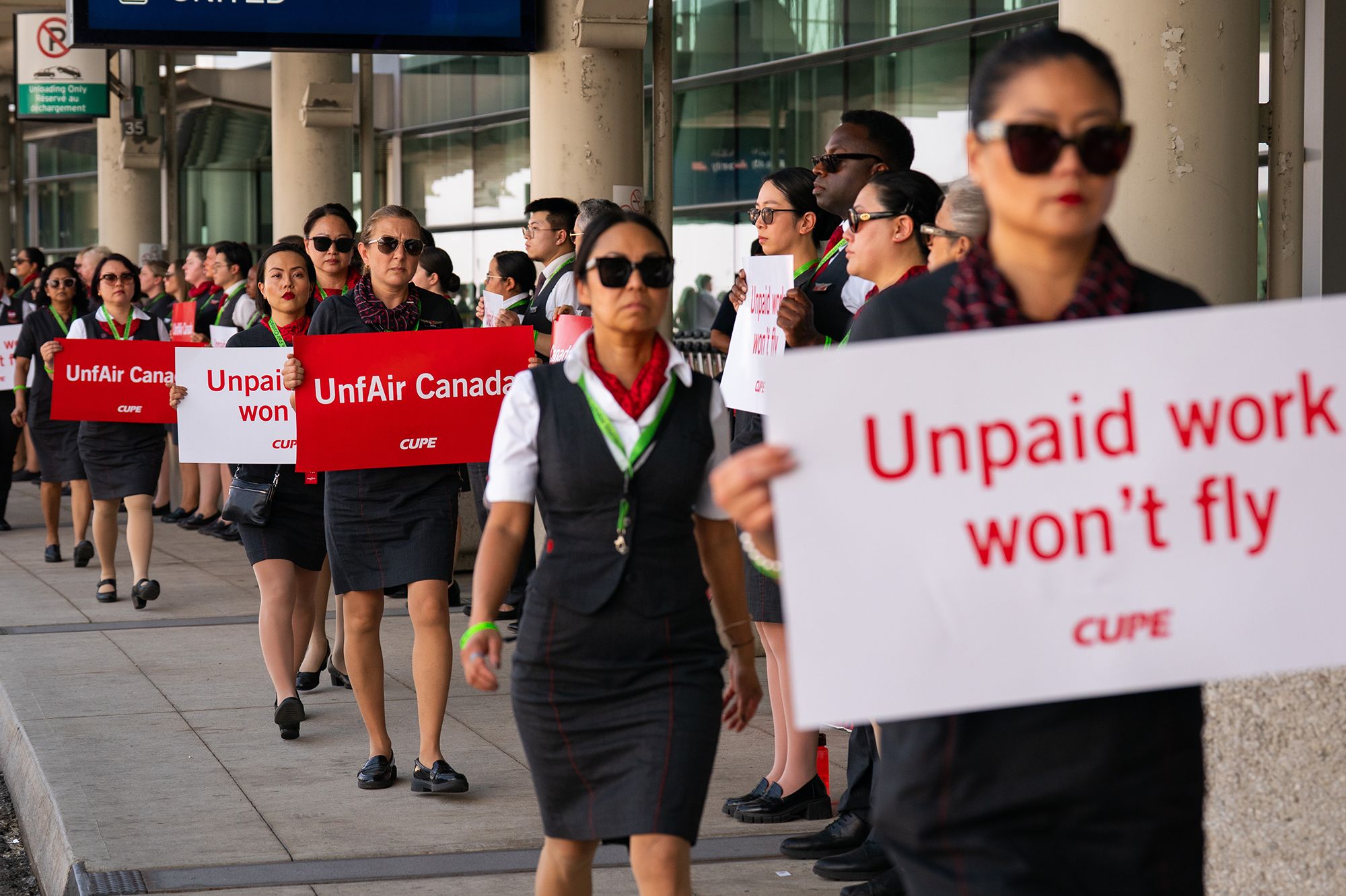 <i>Arlyn McAdorey/Bloomberg/Getty Images via CNN Newsource</i><br/>Air Canada flight attendants are pictured during a demonstration at Toronto Pearson International Airport.