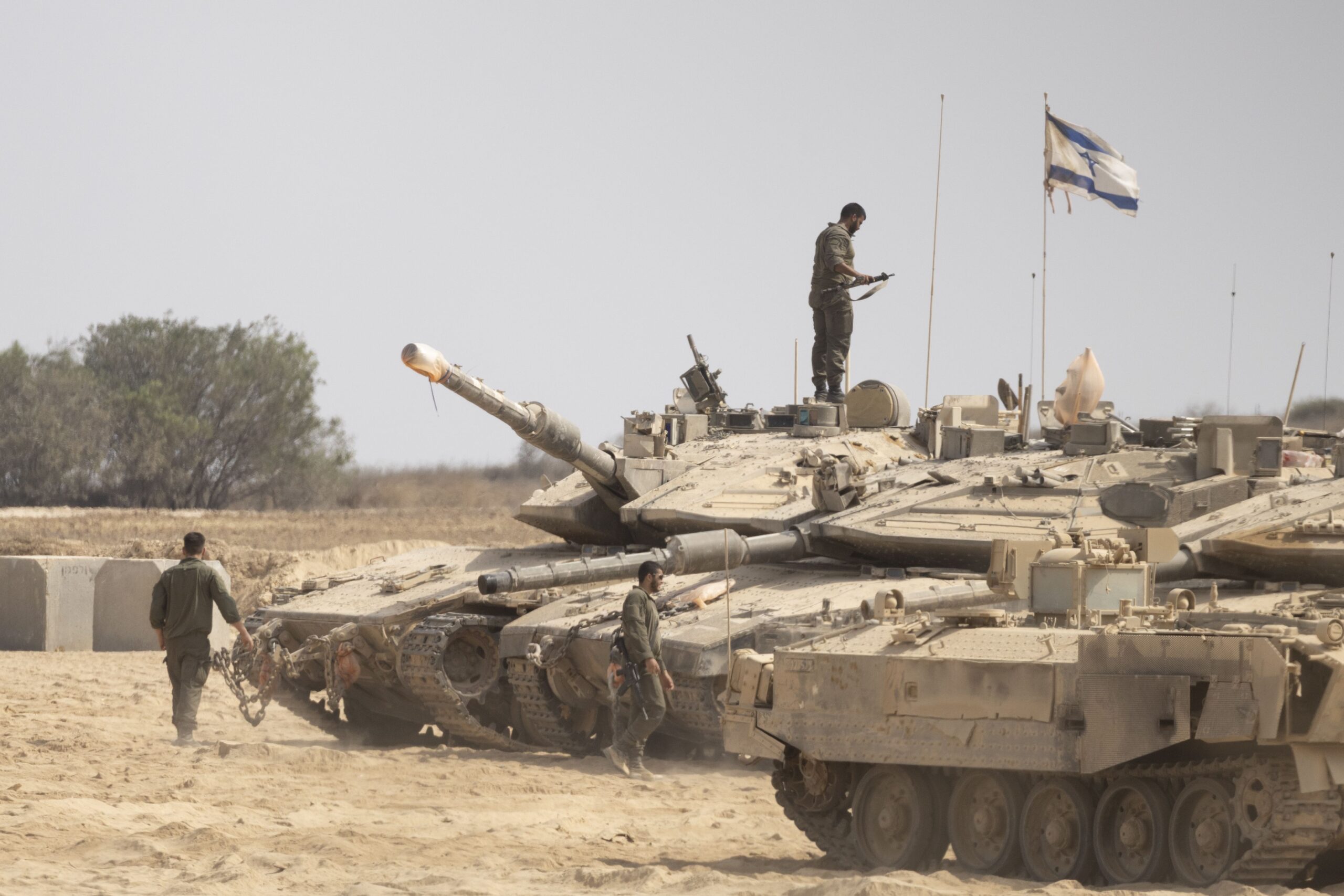 <i>Amir Levy/Getty Images via CNN Newsource</i><br/>Israeli soldiers work near tanks in a gathering point near the border with the Gaza Strip