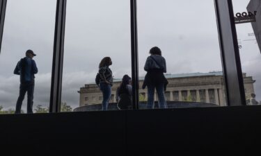 People wait to enter the Smithsonian National Museum of African American History and Culture in Washington