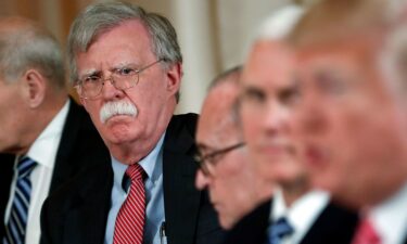 John Bolton listens to President Donald Trump speak during a working lunch in Palm Beach
