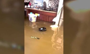 Residents watch helplessly as floodwaters inundate homes and vehicles in deluge that overwhelmed recent flood control improvements.