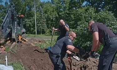 Battle Creek Police Officers dig out 3