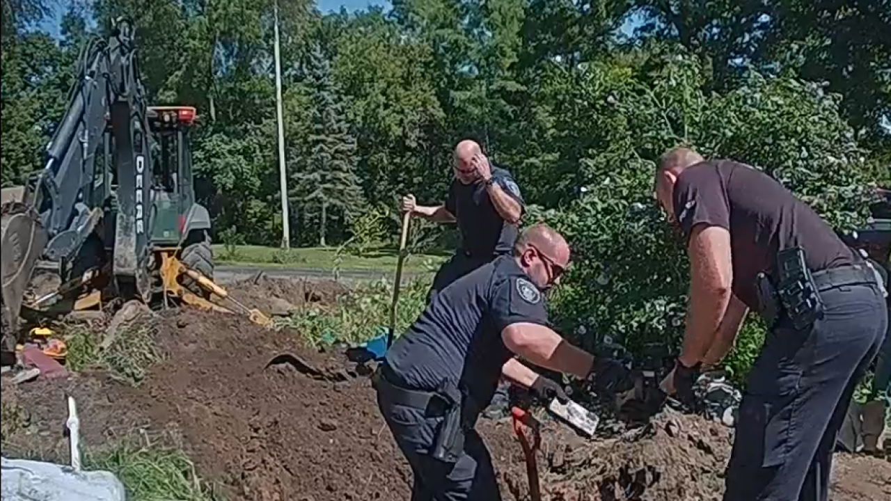 <i>Battle Creek Police Department/WXMI via CNN Newsource</i><br/>Battle Creek Police Officers dig out 3