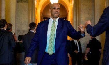 Sen. Cory Booker fist bumps Sen. Eric Schmitt outside the Senate chamber on Capitol Hill on July 28.