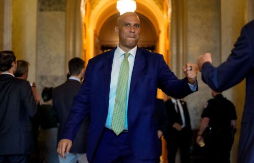 Sen. Cory Booker fist bumps Sen. Eric Schmitt outside the Senate chamber on Capitol Hill on July 28.