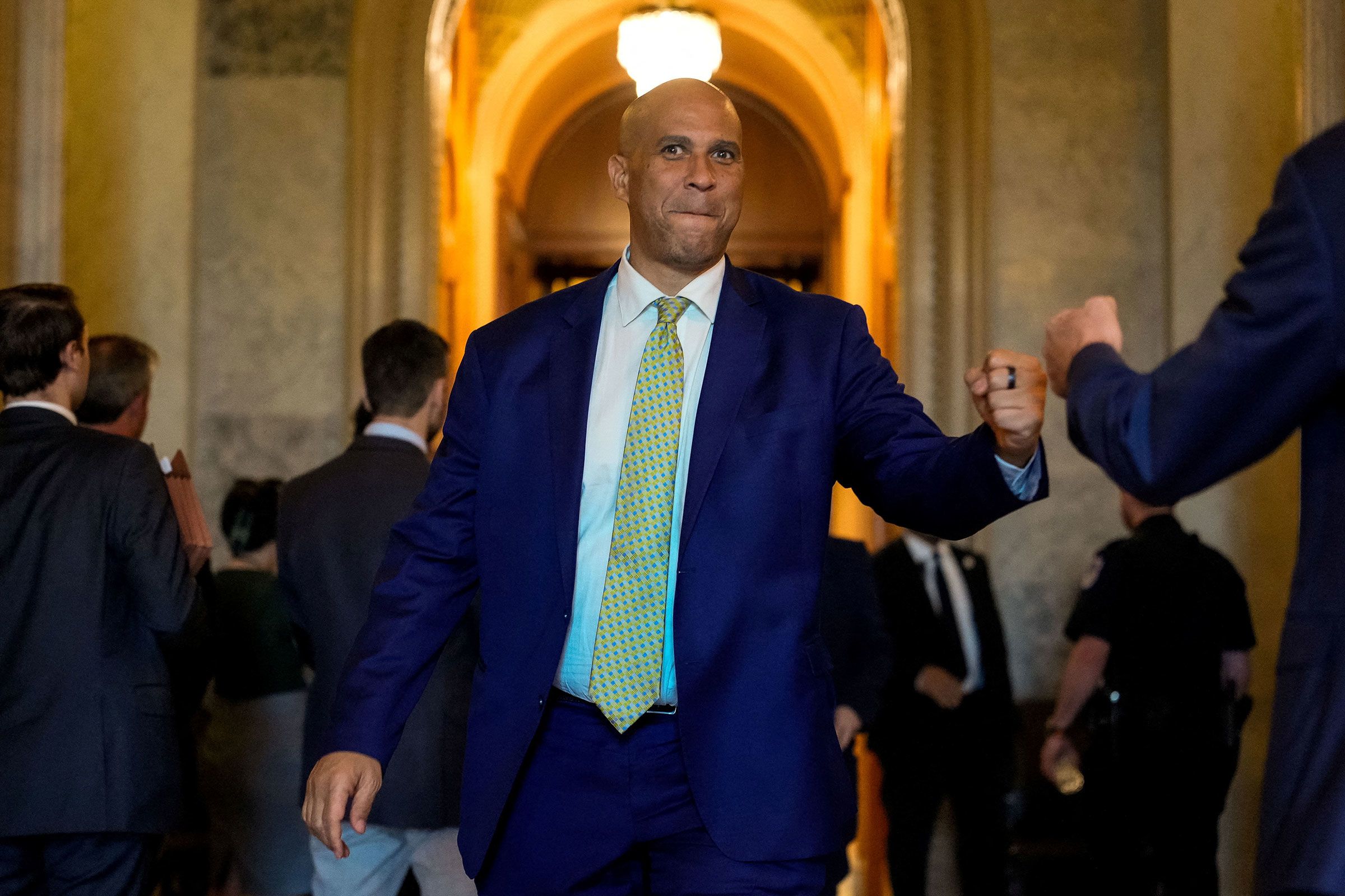 <i>Kent Nishimura/Reuters/File via CNN Newsource</i><br/>Sen. Cory Booker fist bumps Sen. Eric Schmitt outside the Senate chamber on Capitol Hill on July 28.