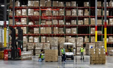 Workers apply labels to boxes of goods in Hagerstown
