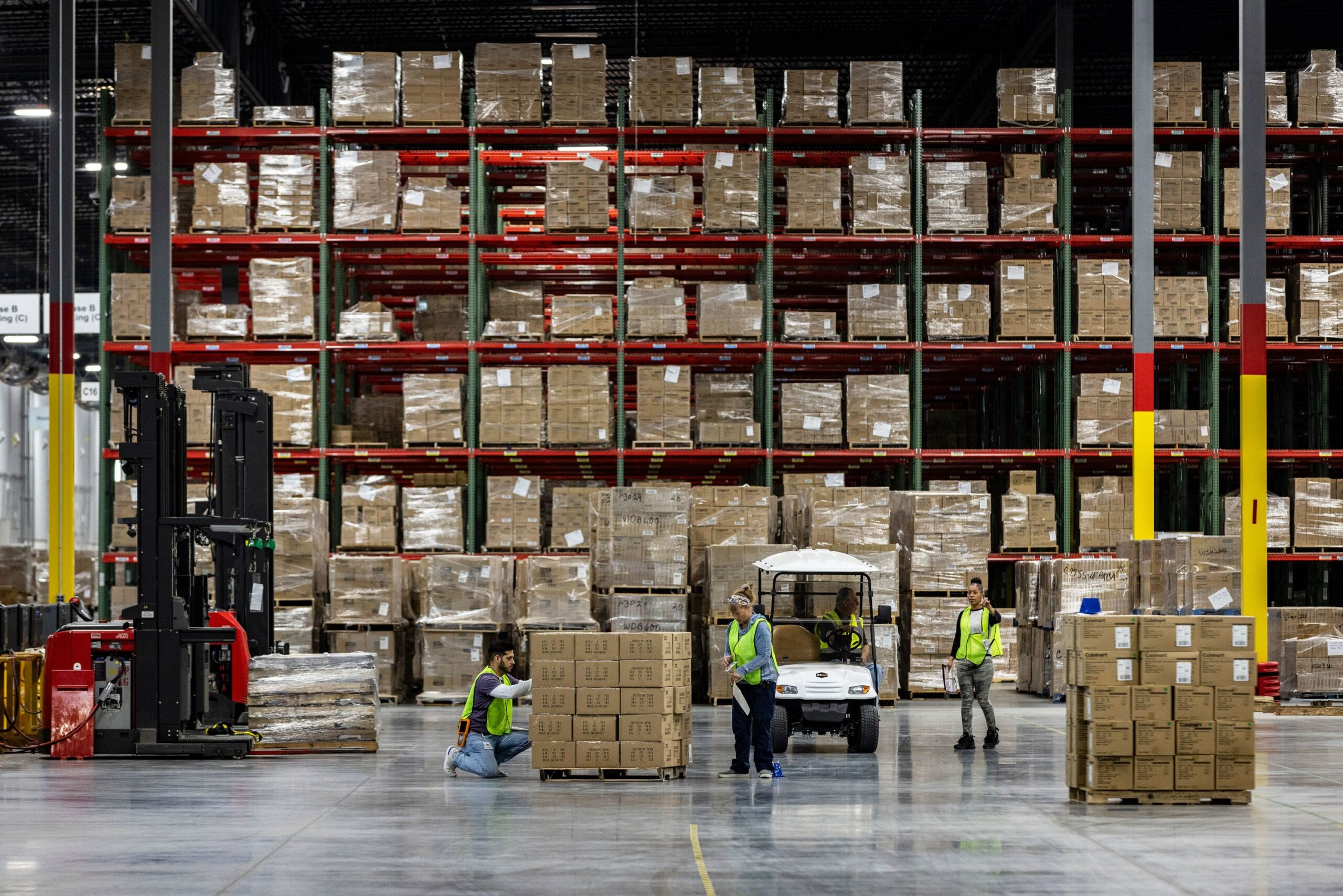 Workers apply labels to boxes of goods in Hagerstown