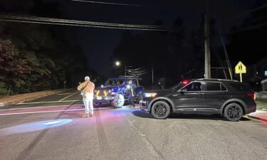 Ambulances are parked outside a hotel that is acting as a reunification center after a shooting at a country club in Nashua