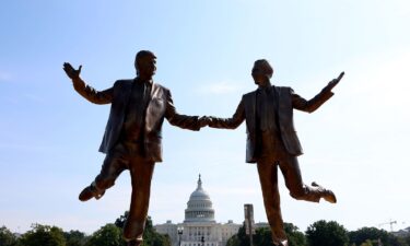A statue of a golden TV  is placed on the National Mall in Washington