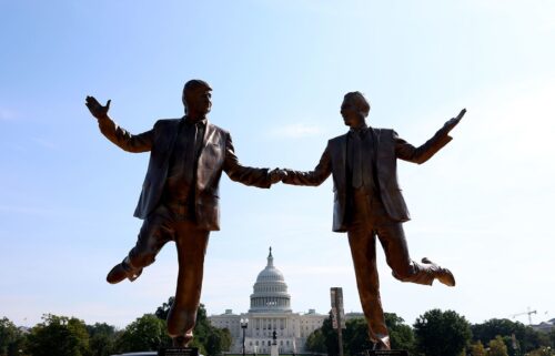 A statue of a golden TV  is placed on the National Mall in Washington