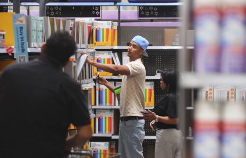 Shoppers look at school supplies at a Walmart in Dallas on August 12.