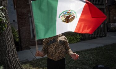 Keilina Zamora prepares to participate in the Mexican Independence Day parade in Chicago's Pilsen neighborhood on Saturday.