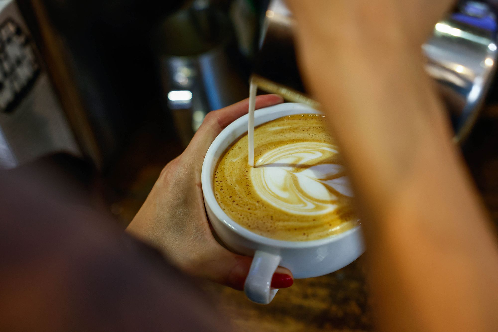 A worker prepares a coffee in New York.
