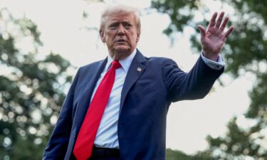 President Donald Trump waves to the media before boarding Marine One in Washington