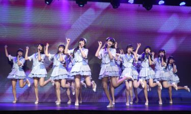 Members of AKB48 are pictured on stage in 2021.