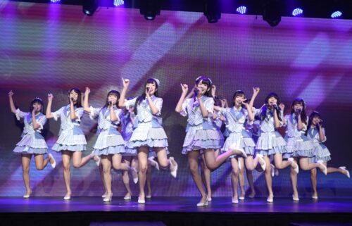 Members of AKB48 are pictured on stage in 2021.