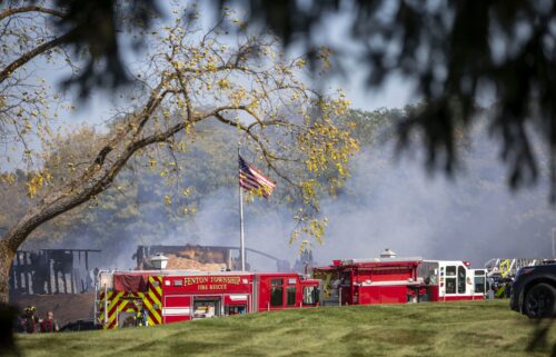 A firefighter walks down the street where emergency services are responding to a shooting and fire at the Church of Jesus Christ of Latter-day Saints in Grand Blanc