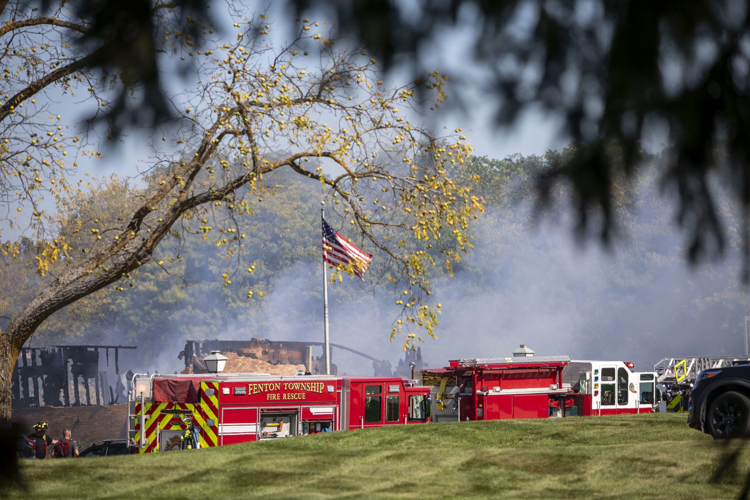 A firefighter walks down the street where emergency services are responding to a shooting and fire at the Church of Jesus Christ of Latter-day Saints in Grand Blanc