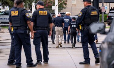 Law enforcement personnel respond at the scene of a shooting at an Immigration and Customs Enforcement field office in Dallas Wednesday.