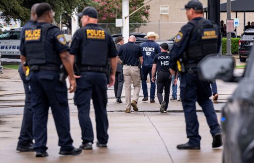 Law enforcement personnel respond at the scene of a shooting at an Immigration and Customs Enforcement field office in Dallas Wednesday.