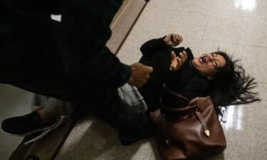 A federal agent restrains a woman on Thursday at an immigration courthouse in New York City.