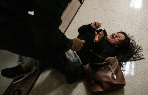 A federal agent restrains a woman on Thursday at an immigration courthouse in New York City.