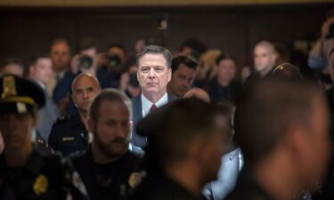 Former FBI director James Comey walks through a corridor on the way to a secure room to continue his testimony to the Senate Select Committee on Intelligence